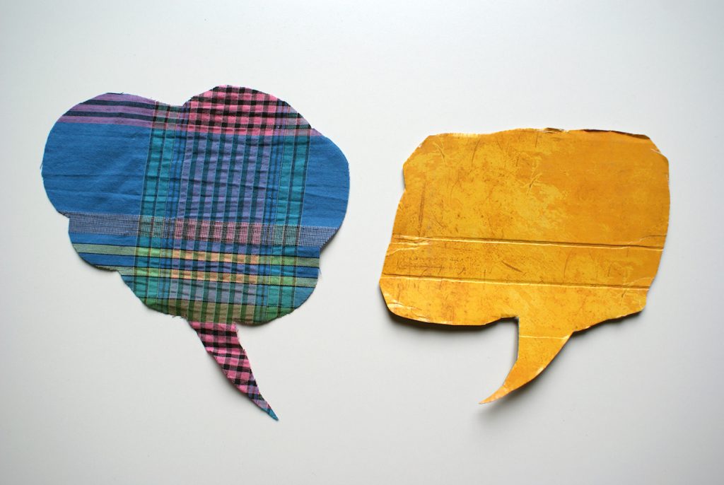 Two word balloons made out of cut fabric
