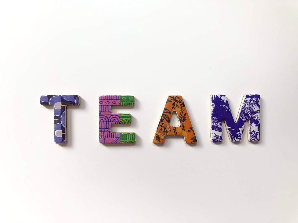 The word "team" spelled out in all caps. Each letter is a different color and pattern.